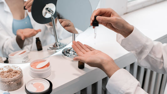 A dropper releasing clear liquid onto an open palm at a skincare counter, illustrating an article on iodine for acne