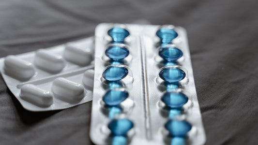 Blister packs of white and blue prescription tablets, illustrating an article about Lamisil terbinafine for toenail fungus