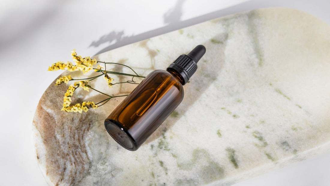 Amber dropper bottle on a pale marble surface