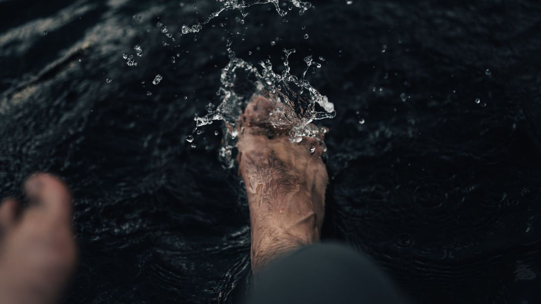 A foot splashing in clear water