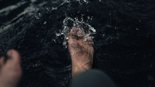 A foot splashing in clear water