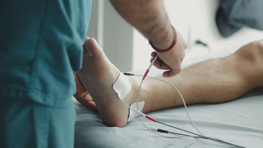 Healthcare worker examining a patient's foot in a clinic