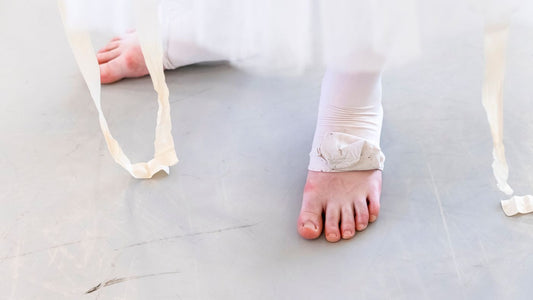 Close up of bare feet on a wooden floor