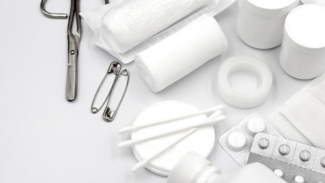 Flat lay of first aid supplies including bandages and scissors