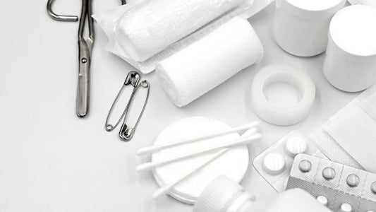 Flat lay of first aid supplies including bandages and scissors