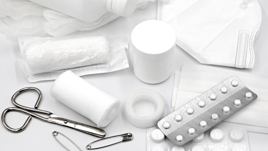 Flat lay of basic first aid supplies on a white background