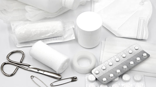 Flat lay of basic first aid supplies on a white background