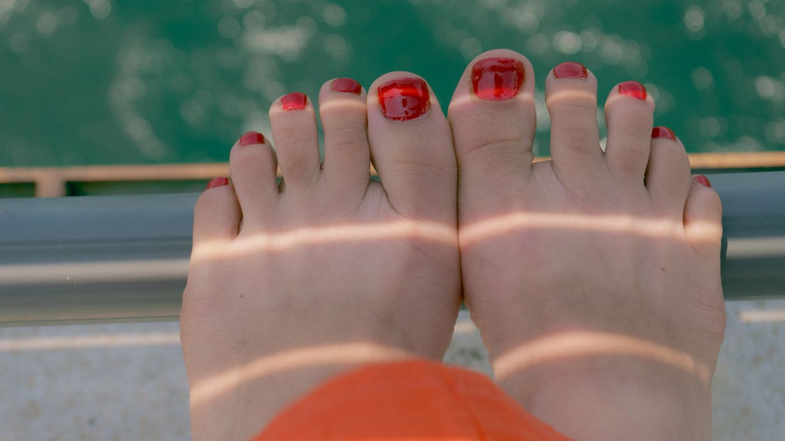 Feet resting beside water on a sunny day