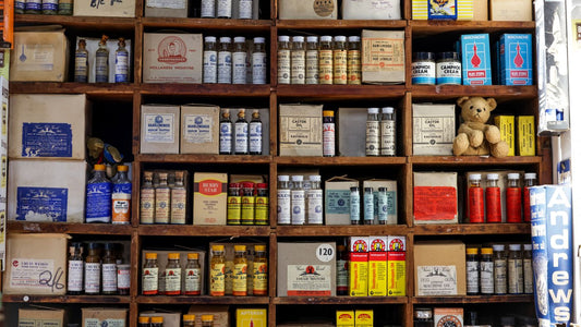 Pharmacy shelf lined with medicine bottles and boxes
