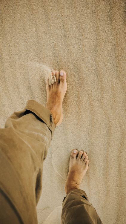Bare feet on beach sand — plantar wart recurrence prevention and treatment
