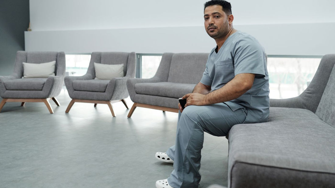Healthcare worker in scrubs resting between shifts
