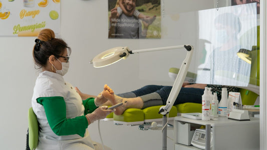 A foot care professional treating a patient in a clinic