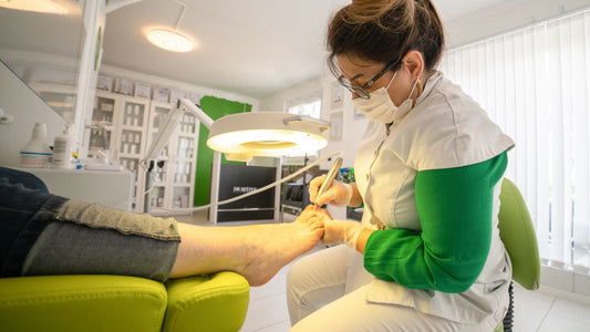 Foot care professional carrying out a treatment with specialist equipment