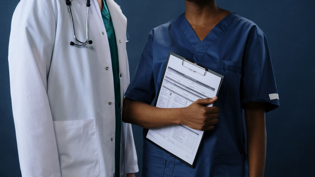 Two healthcare professionals in scrubs at work