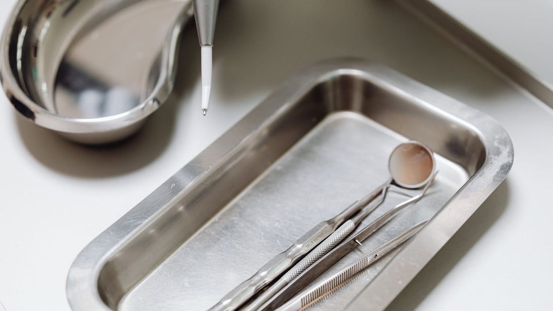 Sterilised metal instruments laid out on a clean tray