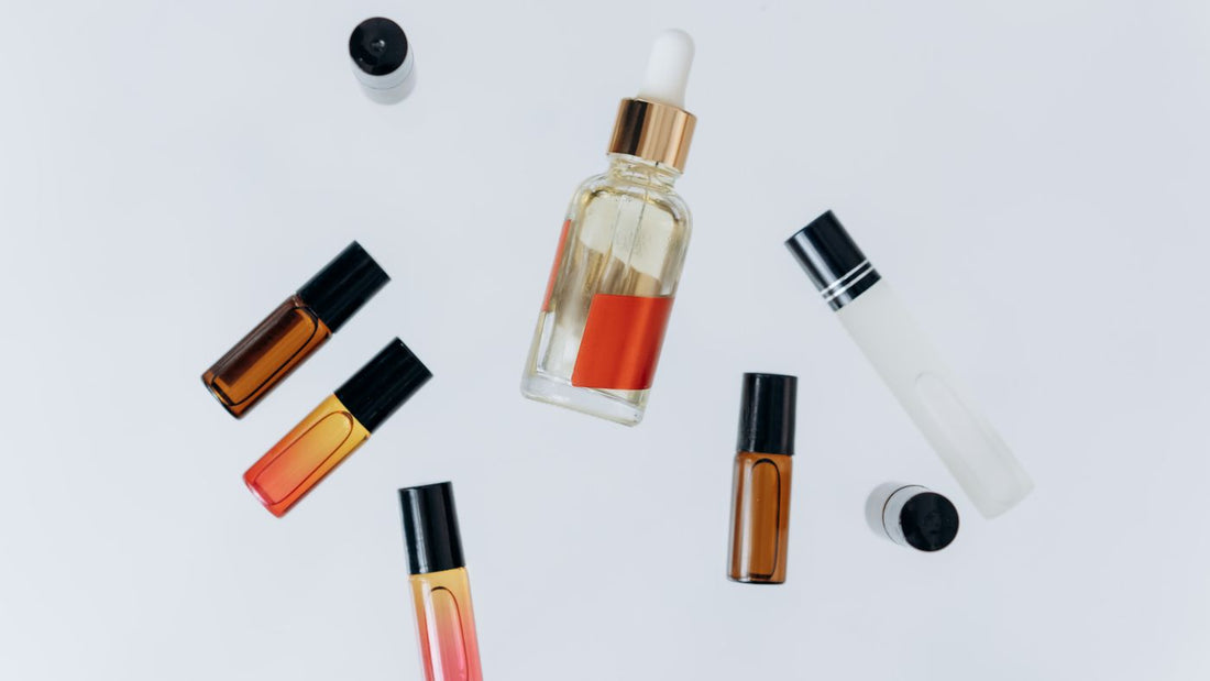 Minimal flat lay of small glass bottles with a pipette