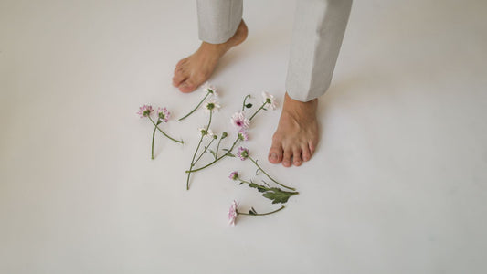 Bare feet standing on a wooden floor