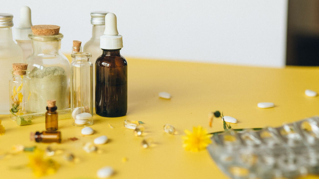 Assorted supplement bottles and capsules on a plain surface