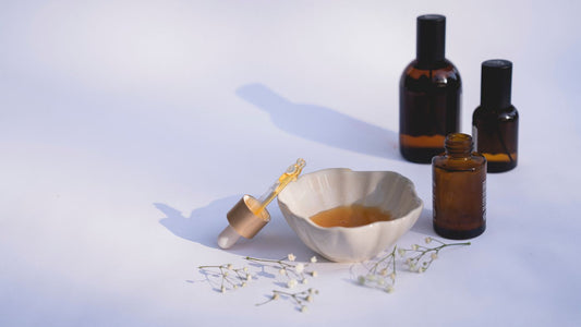 Amber glass bottles with a dropper on a plain surface