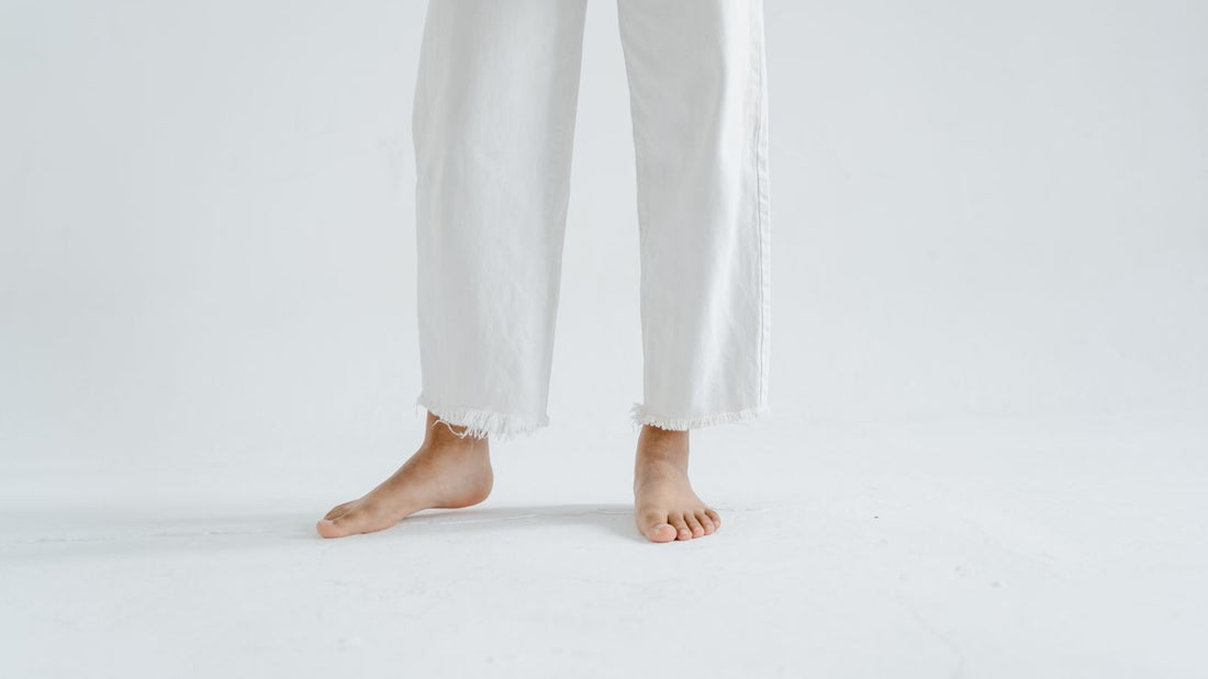 Close up of bare feet against a plain light background