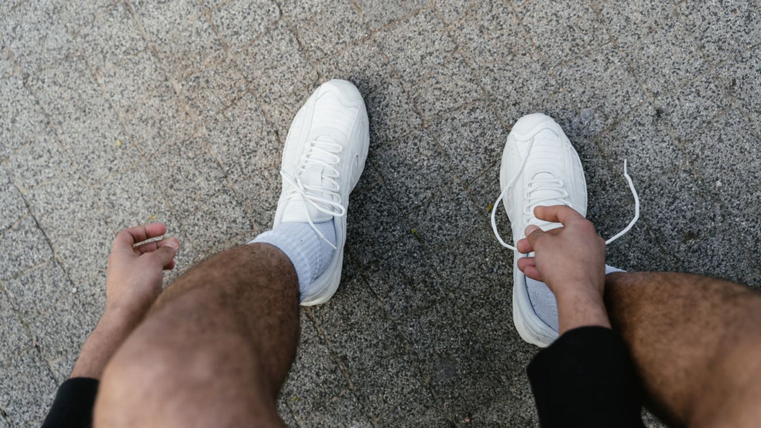 Person lacing up trainers