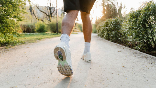 A runner on a park path at sunset