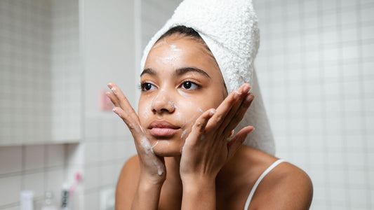 Young person following a simple skincare routine with a towel wrap