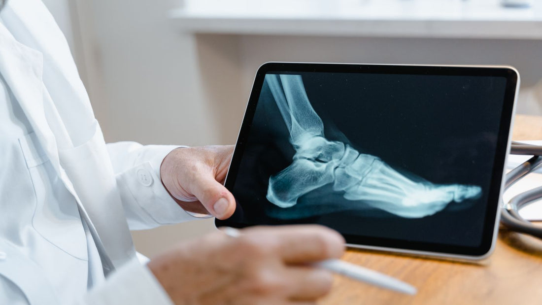 Clinician examining a foot X-ray on a digital tablet