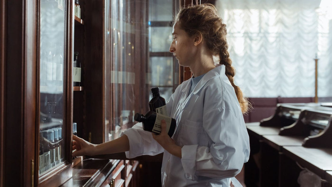 Pharmacist arranging bottles on a pharmacy shelf