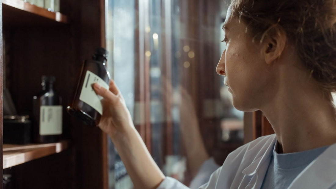 Pharmacist selecting a bottle from a pharmacy shelf