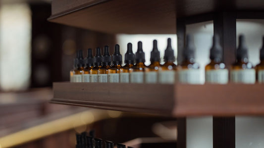 Small dropper bottles arranged on a wooden surface
