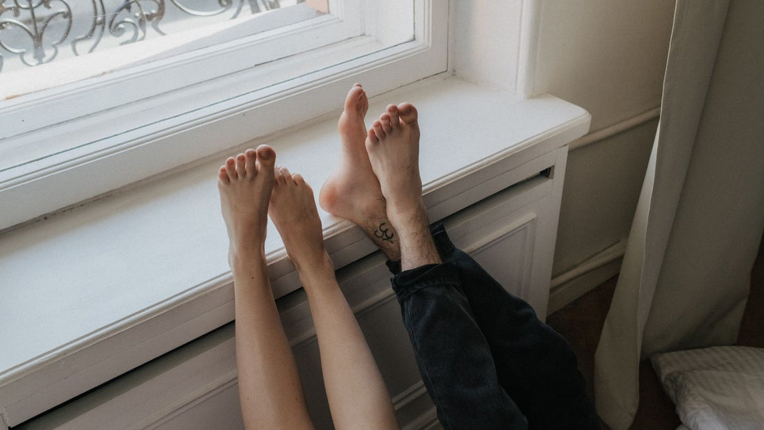 Bare feet resting on a windowsill