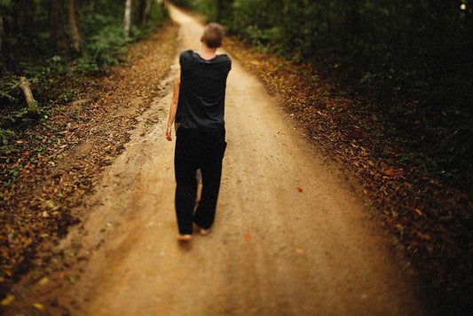 Barefoot walking on stone path — plantar wart causes and prevention