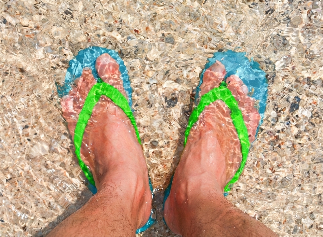 Feet in sandals with clear looking toenails, the appearance result nail gels like Nonyx aim for