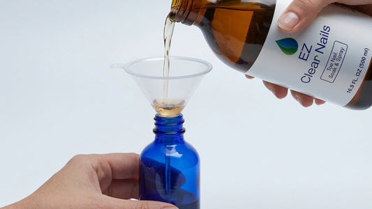 EZ Clear Nails solution being decanted through a funnel into the blue spray bottle from the kit